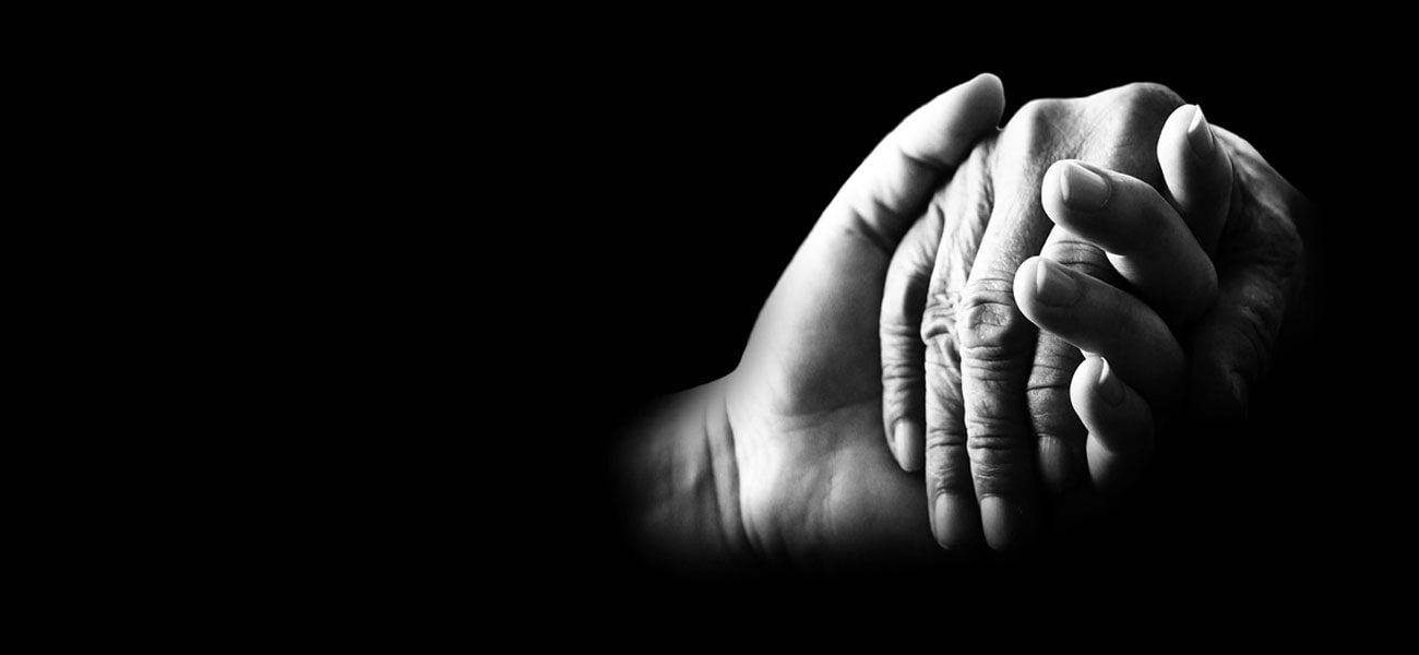 Close-up of young woman's and elderly woman's hands